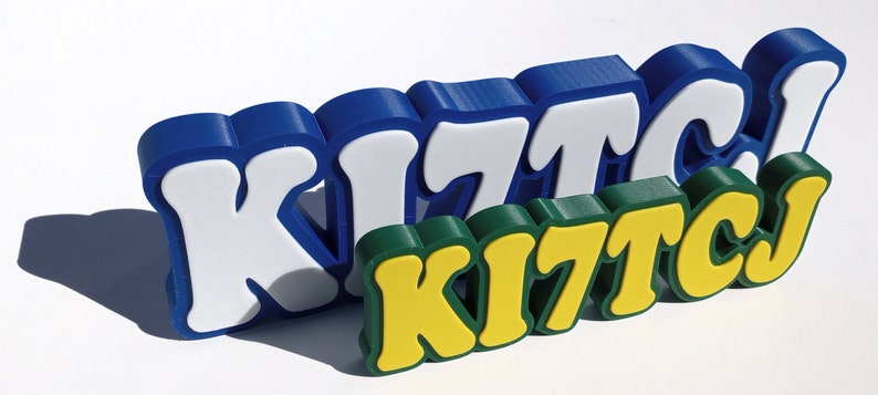 May include: Three dimensional, colorful, plastic letters spelling out the word "KITCJ" in blue, white, green, and yellow.
