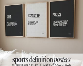 May include: Three framed wall posters featuring dictionary-style definitions. The left poster is black with the word GRIT, the center is white with EXECUTION, and the right is black with FOCUS. Each includes a definition and a small number.