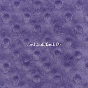 May include: Purple fabric with a textured, dimpled surface. The fabric is called "Jewel Cuddle Dimple Dot".