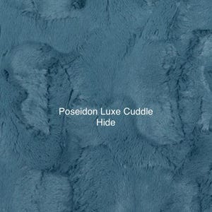 May include: A close-up of a soft, blue, plush fabric with the text "Poseidon Luxe Cuddle Hide" in white.