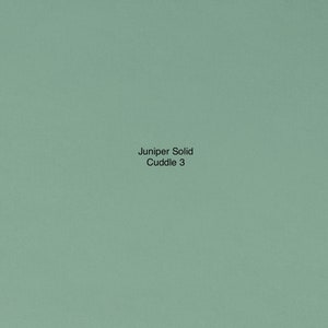 May include: A solid green fabric swatch with the text "Juniper Solid Cuddle 3" printed on it.