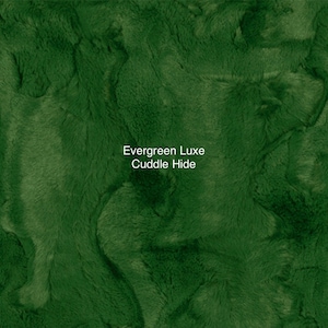 May include: A close-up of a plush, green fabric with a soft, fuzzy texture. The fabric is called "Evergreen Luxe Cuddle Hide".