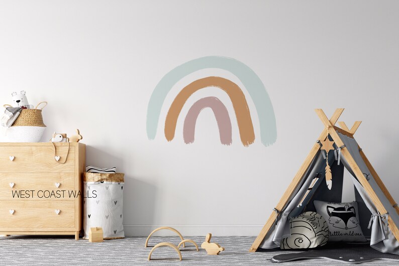 May include: A light blue, brown, and pink rainbow wall decal with a wooden teepee tent and a star-shaped dream catcher hanging from the top.