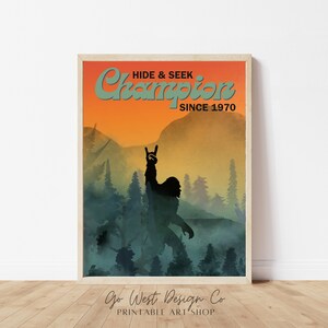 May include: A retro-style poster with a silhouette of a Bigfoot-like creature with a llama head, standing in a forest with a sunset in the background. The text reads "Hide & Seek Champion Since 1970" and "Go West Design Co. Printable Art Shop".