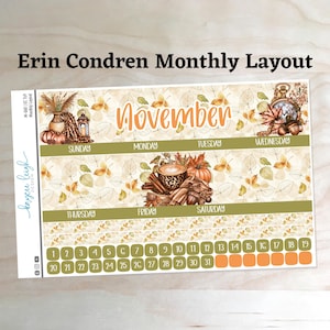 May include: A November monthly calendar sticker sheet featuring autumn-themed illustrations of pumpkins, leaves, a coffee cup, and a clock. The layout includes headers for days of the week, numbered date boxes from 1 to 31, and decorative borders.