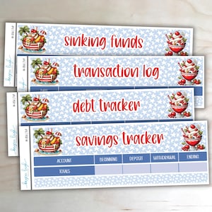 May include: Four rectangular planner stickers with text in red: "sinking funds", "transaction log", "debt tracker", and "savings tracker". Each sticker has a blue and white pattern and a dessert graphic.