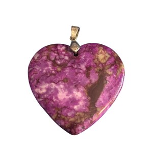 May include: A heart-shaped pendant with a silver-colored bail. The pendant is a mix of purple, brown, and tan colors. The stone has a marbled appearance. The pendant is a unique piece of jewelry.