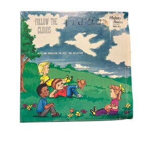 Puede incluir: Una portada de álbum de vinilo vintage con una ilustración de dibujos animados de tres niños sentados en una colina cubierta de hierba bajo un cielo azul con nubes blancas. El título del álbum es "Follow the Clouds" y la discográfica es "Melody House Records".