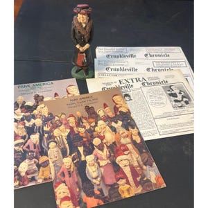 May include: A vintage figurine of a woman in a hat and coat, holding a purse, stands near printed materials. The materials include newspapers and booklets titled "Park America" and "Crunkleville Chronicle". The image has a vintage aesthetic.