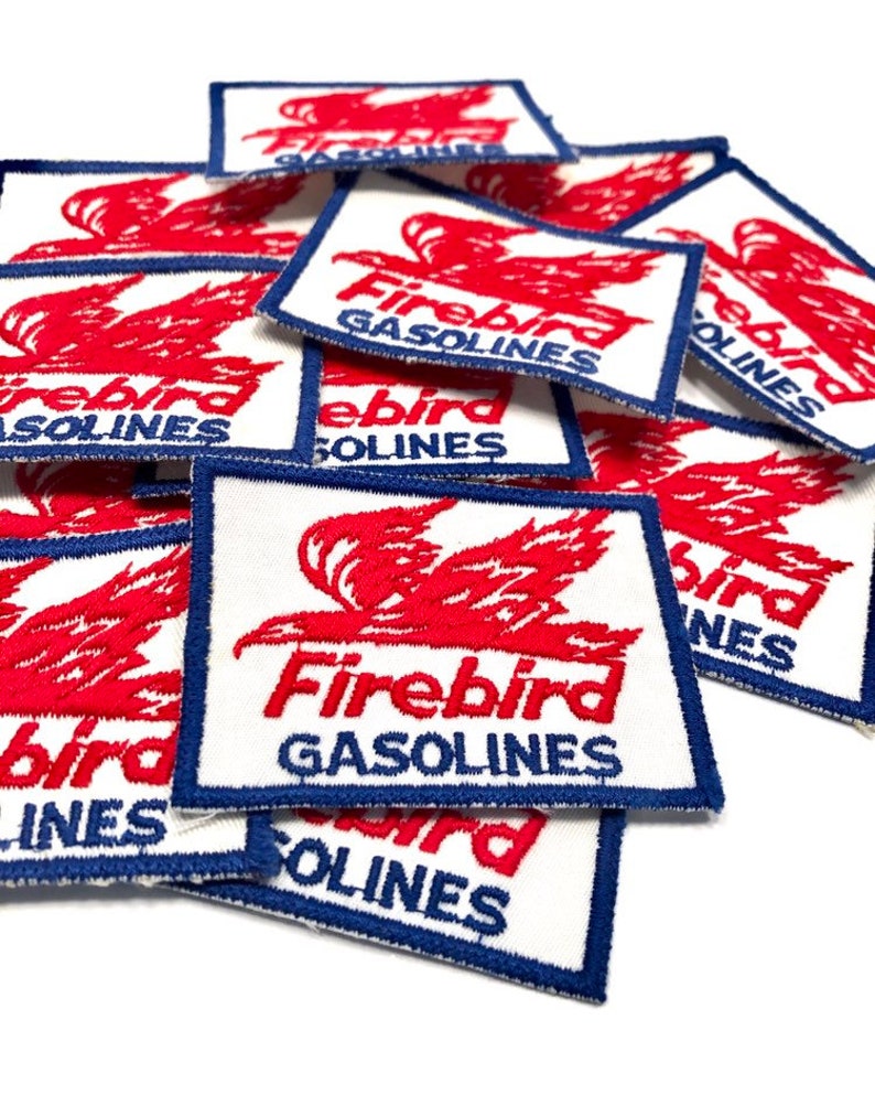 May include: A stack of white fabric patches with red and blue embroidery. The patches feature a stylized red bird with the text "Firebird Gasolines".