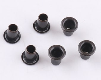 May include: Six black metal eyelets with a shiny finish. The eyelets are used for crafts and leatherwork.