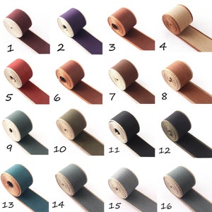 May include: A set of 16 different coloured cotton webbing straps with a natural linen edge. The straps are numbered 1 through 16.