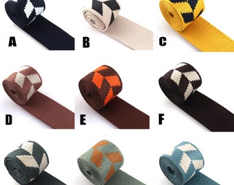 May include: Nine different colors of woven webbing with a geometric pattern. The webbing is available in black and white, beige and black, yellow and black, brown and white, orange and brown, brown and white, green and white, brown and orange, and blue and white.