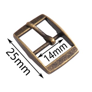 May include: Antique gold-tone metal buckle with a rectangular shape. The buckle measures 1.0 inches wide and 2.5 inches long.