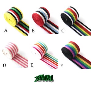 May include: Six different striped ribbon trims, each with a different colour combination. The ribbons are 38mm wide and are made of a woven fabric. The colours include yellow, red, black, white, pink, green, blue, and orange.