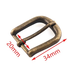 May include: Antique gold-tone metal belt buckle with a 34 mm by 20 mm size.