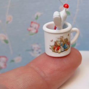 Dollhouse Peter rabbit mug with toothpaste and toothbrush. Beatrix Potter nursery.
