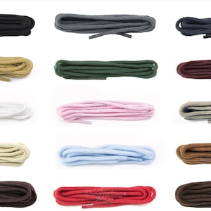 May include: An assortment of shoelaces in a range of colours: black, grey, navy, beige, dark green, burgundy, white, pink, taupe, light beige, light blue, and brown. Each pair is neatly coiled, displaying the variety of colours available.