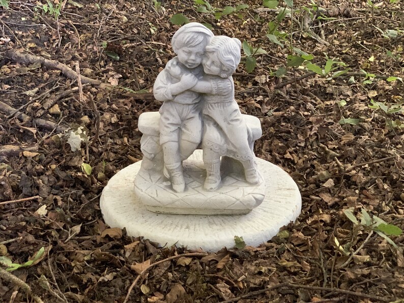 Two children hugging on a bench garden statue Boy and girl Etsy