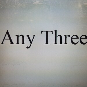 May include: The words "Any Three" are displayed in a black, serif font against a light gray background. The text is centered and appears to be a title or a heading.