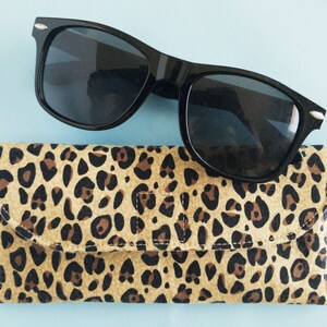 This leopard print glasses case has a magnetic clasp closure and soft godlen tan fleece inside. It is padded with fusible fleece to protect her sunglasses or readers. Its the perfect gift for mom grandma or animal print lovers.