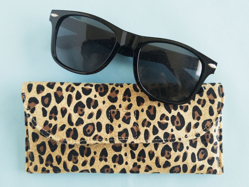 This leopard print glasses case has a magnetic clasp closure and soft godlen tan fleece inside. It is padded with fusible fleece to protect her sunglasses or readers. Its the perfect gift for mom grandma or animal print lovers.
