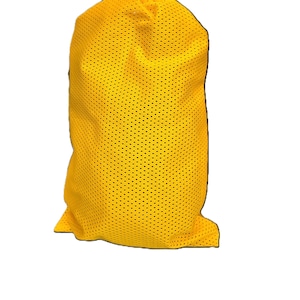 May include: A bright yellow laundry bag constructed from a lightweight, breathable mesh fabric. The bag features a cylindrical shape with a gathered top opening, showcasing a consistent perforated texture throughout the entire exterior surface.