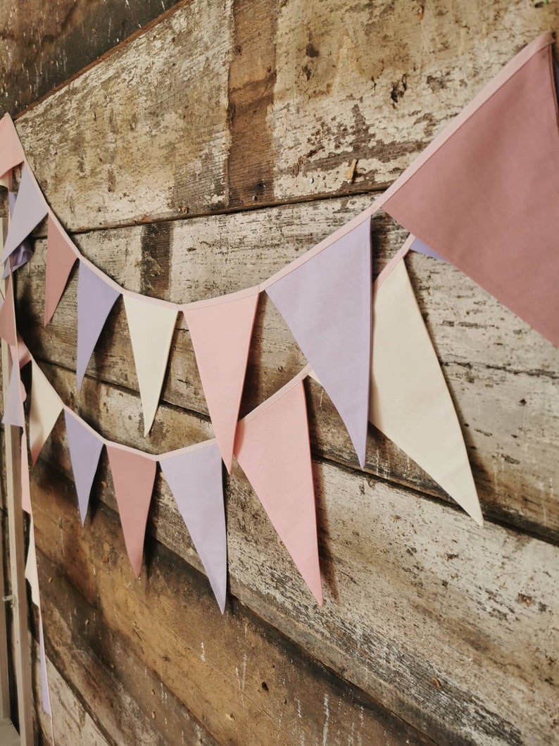 Wall decor will be great accessorie for kids party, baby shower and nursery. Bunting banner made of 100% pure cotton. Triangles are sewn double layer and are handmade. Old pink, violet, off white color. In one metre are 6 pieces of fabric flags.