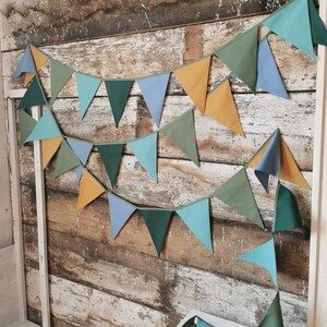 Garland decor will be great accessorie for kids party, baby shower and nursery. Bunting banner made of 100% pure cotton. Triangles are sewn double layer and are handmade. Green, mustard, sea blue dark color. In one metre are 6 pieces of fabric flags.