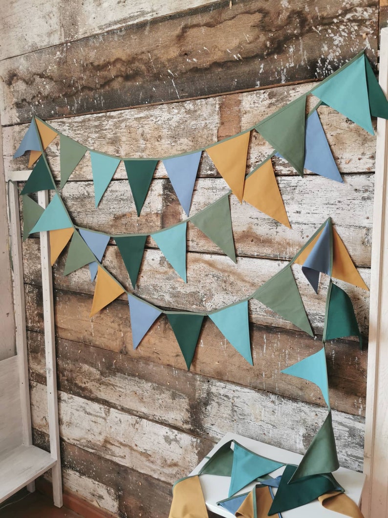 Garland decor will be great accessorie for kids party, baby shower and nursery. Bunting banner made of 100% pure cotton. Triangles are sewn double layer and are handmade. Green, mustard, sea blue dark color. In one metre are 6 pieces of fabric flags.