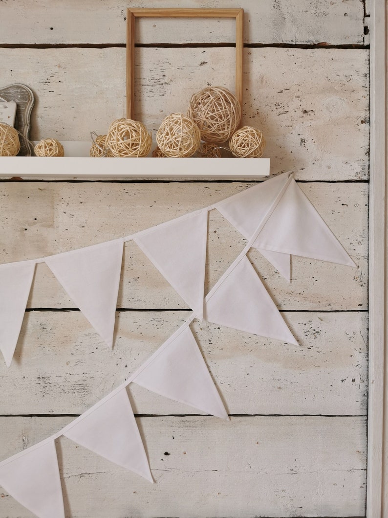 Cotton fabric bunting banner in white color. Ideal solution for birthday party, baby shower, weddings, garden festive. In one meter are 6 pieces flags. Many meters available. Garland for nursery