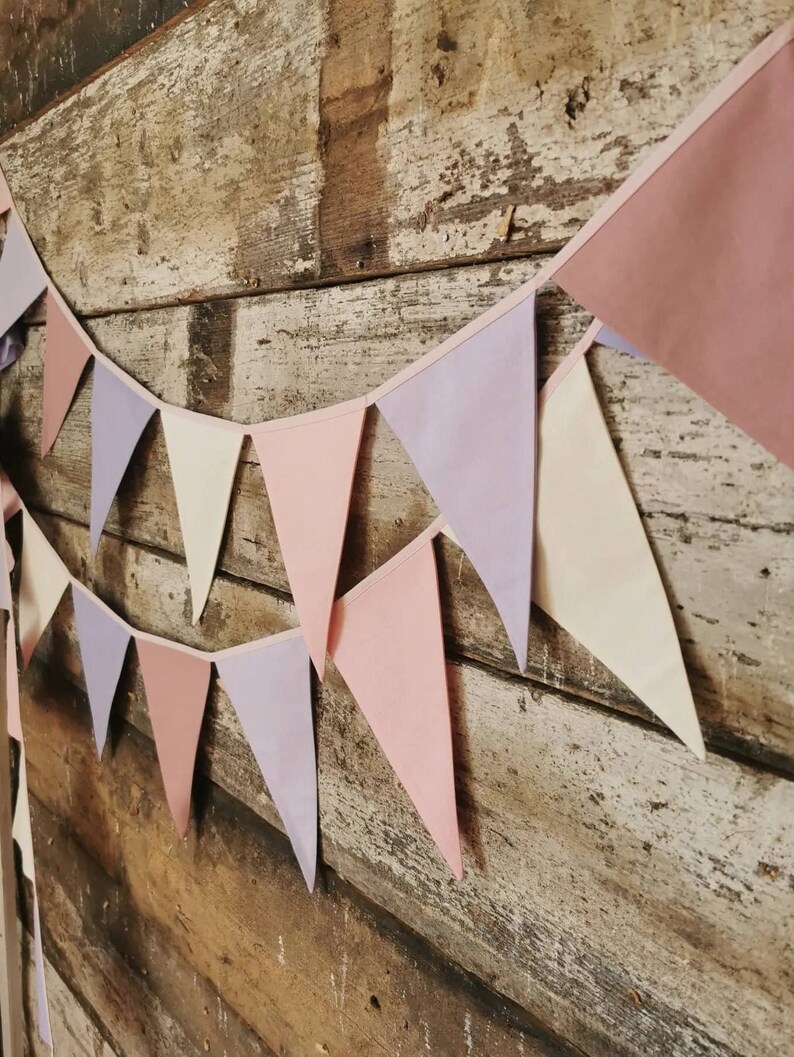 Wall decor will be great accessorie for kids party, baby shower and nursery. Bunting banner made of 100% pure cotton. Triangles are sewn double layer and are handmade. Old pink, violet, off white color. In one metre are 6 pieces of fabric flags.