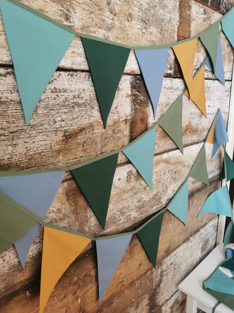 Garland decor will be great accessorie for kids party, baby shower and nursery. Bunting banner made of 100% pure cotton. Triangles are sewn double layer and are handmade. Green, mustard, sea blue dark color. In one metre are 6 pieces of fabric flags.