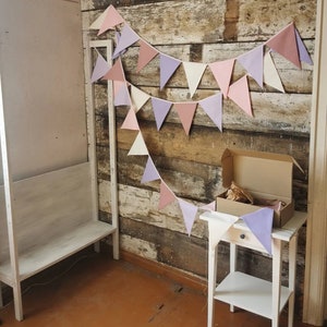 Wall decor will be great accessorie for kids party, baby shower and nursery. Bunting banner made of 100% pure cotton. Triangles are sewn double layer and are handmade. Old pink, violet, off white color. In one metre are 6 pieces of fabric flags.