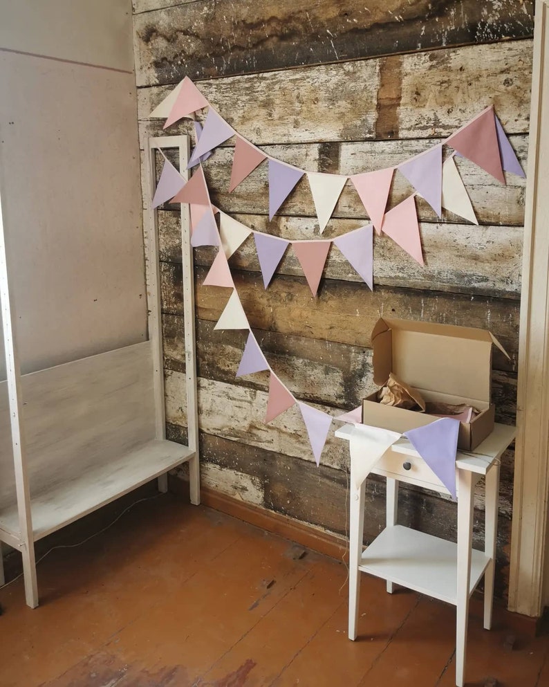 Wall decor will be great accessorie for kids party, baby shower and nursery. Bunting banner made of 100% pure cotton. Triangles are sewn double layer and are handmade. Old pink, violet, off white color. In one metre are 6 pieces of fabric flags.