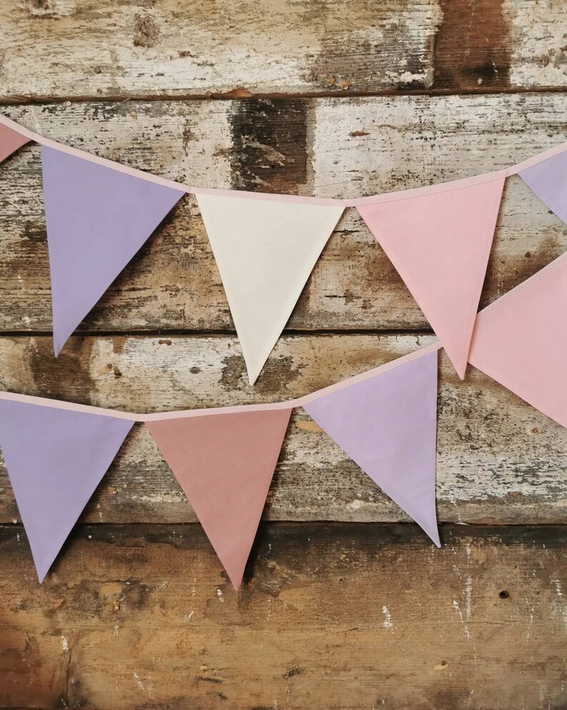 Wall decor will be great accessorie for kids party, baby shower and nursery. Bunting banner made of 100% pure cotton. Triangles are sewn double layer and are handmade. Old pink, violet, off white color. In one metre are 6 pieces of fabric flags.