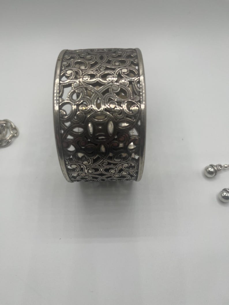 May include: A set of three ceramic mugs with a speckled, matte finish. The mugs are in shades of cream, light gray, and dark gray. Each mug has a simple, minimalist design and a rounded handle.