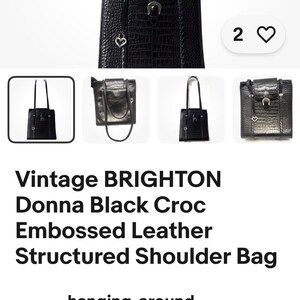 May include: Black Brighton Donna shoulder bag with a crocodile-embossed leather texture. The bag has a structured design, a top handle, and decorative hardware. The bag has a heart-shaped charm and a horseshoe charm.