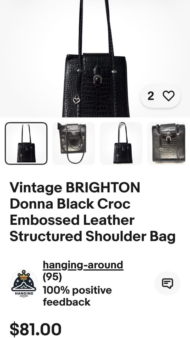 May include: Black Brighton Donna shoulder bag with a crocodile-embossed leather texture. The bag has a structured design, a top handle, and decorative hardware. The bag has a heart-shaped charm and a horseshoe charm.
