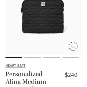 May include: Black quilted crossbody bag with heart-shaped stitching. The bag has a silver zip and a small silver emblem. The text "HEART BEAT" is above the text "Personalized Alina Medium Cross Body".