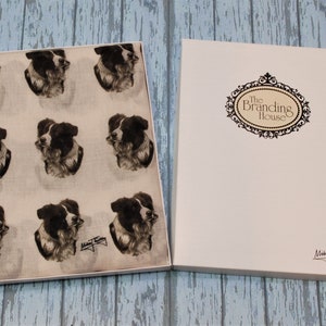 May include: A white gift box with a black and white border collie print scarf inside. The box has the text "The Branding House" on the front and a signature on the bottom.