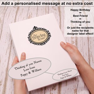 May include: A rectangular white box featuring a black ornate logo for The Branding House. The box displays a personalized message reading Thinking of you Nanna Love from Poppy & William, with additional text options for custom labels.