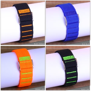 May include: Four different colored watch bands with contrasting colored stripes. The bands are black with orange stripes, blue with blue stripes, orange with green stripes, and black with green stripes.