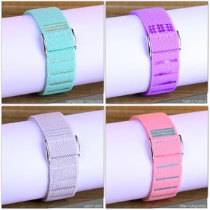 May include: Four different colored elastic watch bands with silver clasps. The colors are turquoise, purple, light grey, and pink turquoise.