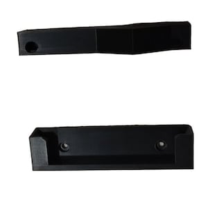 May include: Two black plastic wall mount brackets. The top bracket has a curved shape and a small hole. The bottom bracket has a rectangular shape with two small holes.