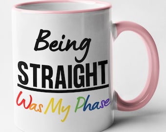 May include: White ceramic mug with a pink rim and handle. The mug has black text that reads "Being Straight Was My Phase" with the words "Was My Phase" in rainbow colors.