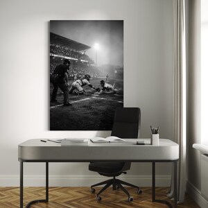May include: A black and white wall art print depicting a baseball game in progress at night under stadium lights. The scene shows a runner sliding into home plate while the catcher attempts a tag, with an umpire standing nearby on the dirt field.