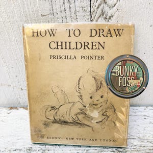 May include: Vintage book titled "How to Draw Children" by Priscilla Pointer. The cover features a black and white illustration of a baby lying on its stomach.