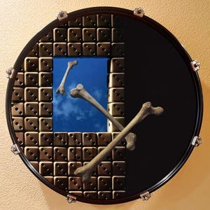 May include: A surreal image featuring a black drum with a section of dice-shaped blocks. A square window reveals a blue sky with clouds, and several bones are positioned across the drum's surface. The drum has silver hardware.