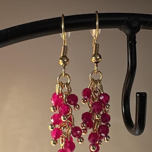 May include: A white ceramic mug with a black handle and the text "But First, Coffee" in a black, bold font. The mug is on a white surface.